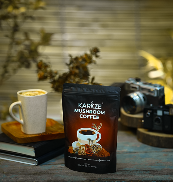 Karkze Mushroom Coffee pack on table with cup and camera.